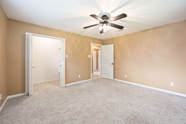 interior space featuring light carpet, a closet, and ceiling fan