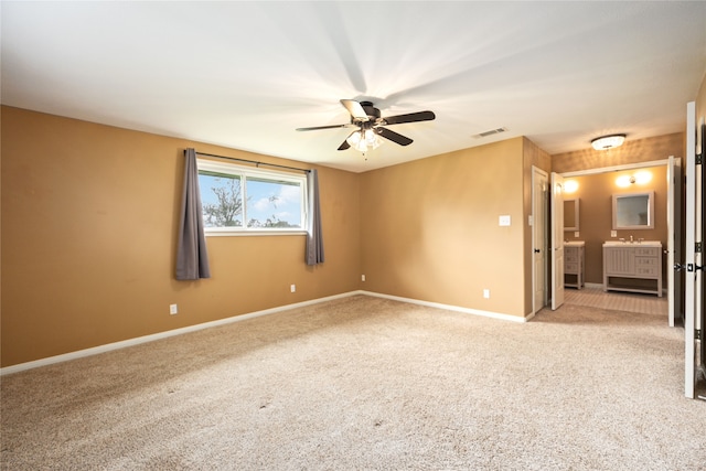 carpeted empty room featuring ceiling fan