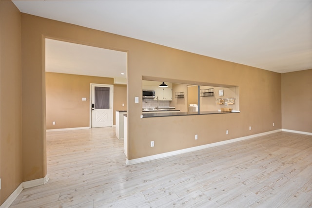 unfurnished living room featuring light wood-type flooring