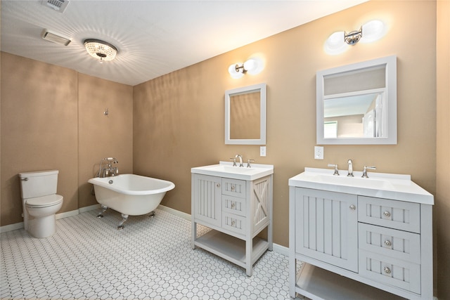 bathroom featuring vanity, toilet, and a washtub