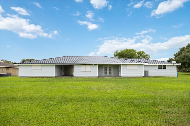 back of property with a lawn and cooling unit