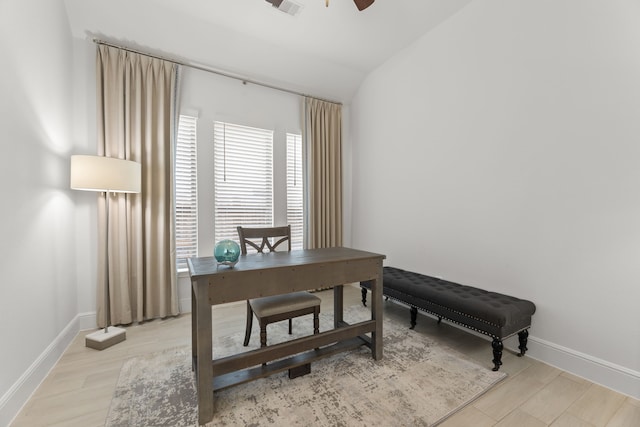 office featuring light hardwood / wood-style flooring, lofted ceiling, and ceiling fan