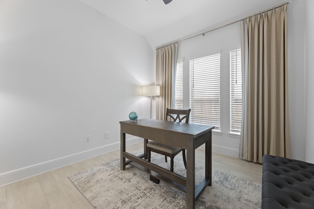 office space featuring light hardwood / wood-style floors, lofted ceiling, ceiling fan, and plenty of natural light