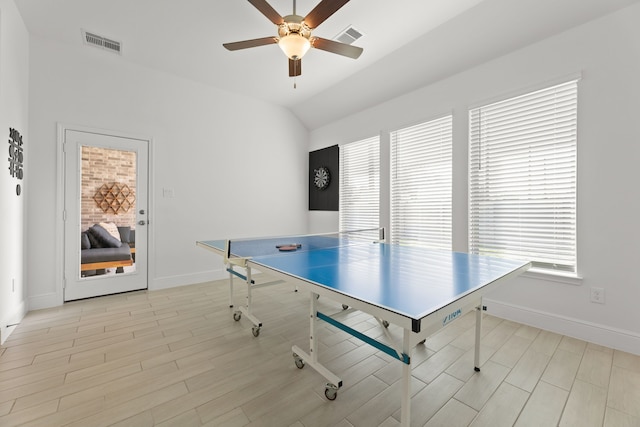 playroom with light hardwood / wood-style floors, a healthy amount of sunlight, lofted ceiling, and ceiling fan