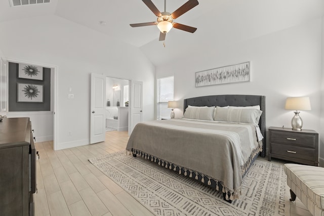 bedroom with ceiling fan, connected bathroom, light hardwood / wood-style floors, and high vaulted ceiling