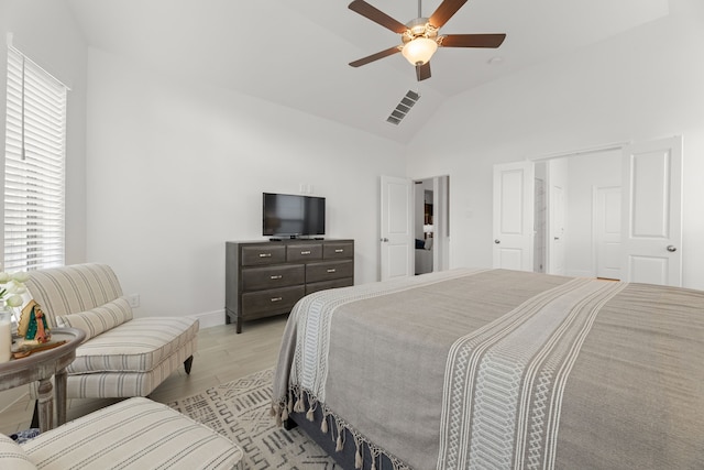 bedroom featuring high vaulted ceiling, light hardwood / wood-style floors, and ceiling fan