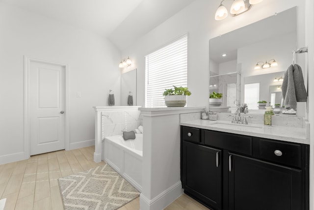 bathroom featuring independent shower and bath, vanity, hardwood / wood-style floors, and plenty of natural light