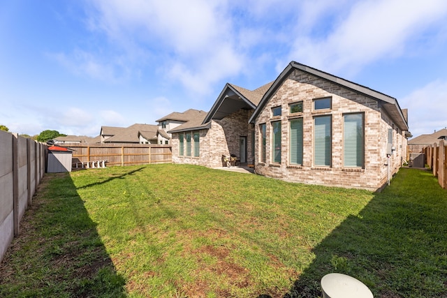 rear view of house featuring cooling unit and a yard