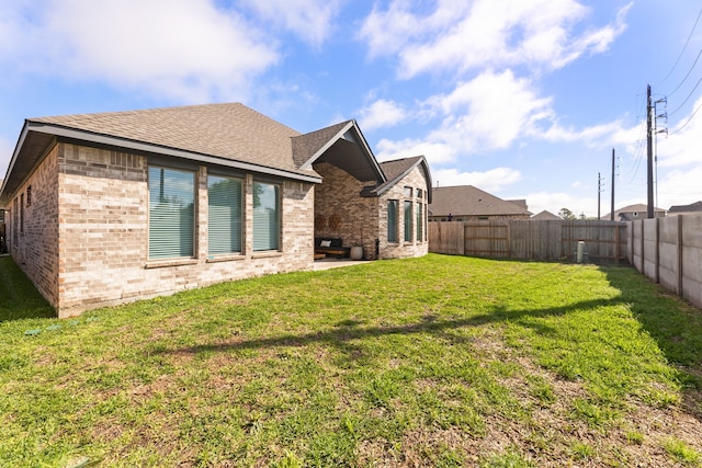 rear view of house with a lawn and a patio area