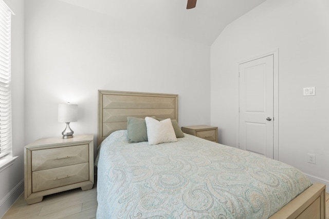 bedroom with light wood-type flooring, lofted ceiling, and ceiling fan