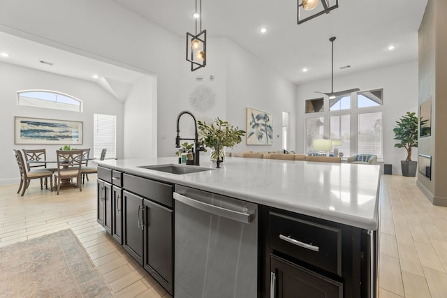 kitchen with a center island with sink, sink, a healthy amount of sunlight, and stainless steel dishwasher