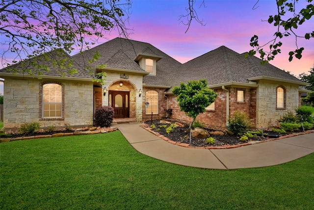 french provincial home with a yard