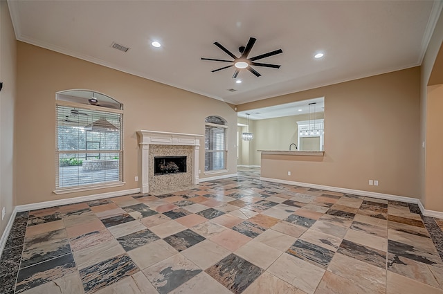 unfurnished living room featuring ornamental molding, a fireplace, and ceiling fan