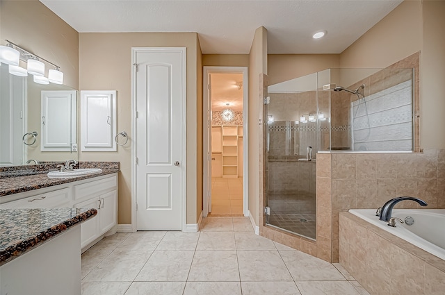 bathroom featuring vanity, tile patterned floors, and separate shower and tub