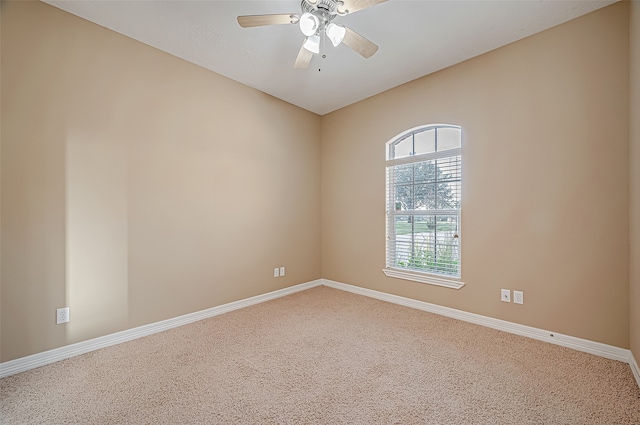 carpeted spare room with ceiling fan