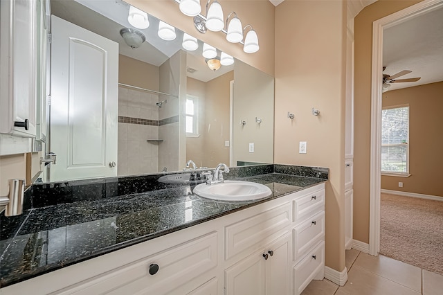 bathroom featuring vanity, ceiling fan, tile patterned floors, and tiled shower