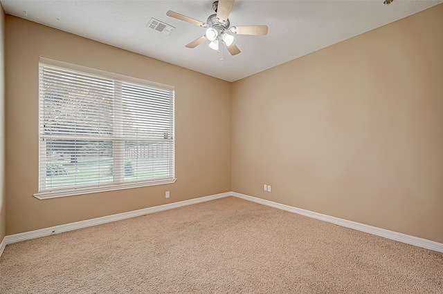 spare room featuring carpet flooring and ceiling fan