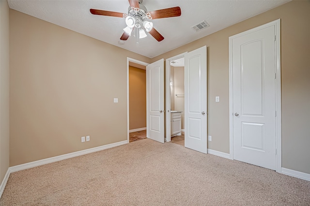 unfurnished bedroom featuring ceiling fan and light colored carpet