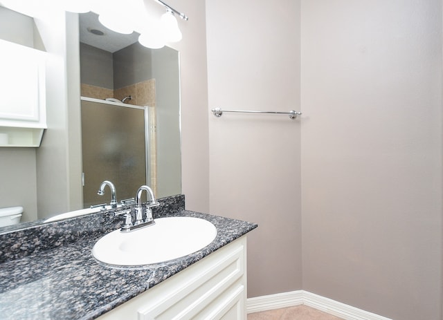 bathroom with vanity, toilet, and an enclosed shower