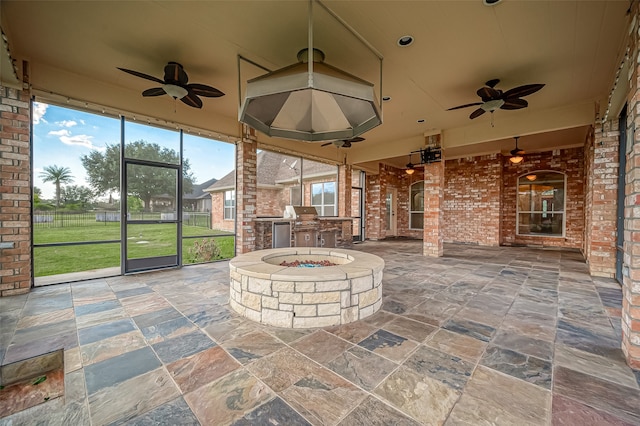 unfurnished sunroom featuring ceiling fan