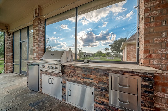 view of patio with sink, exterior kitchen, and area for grilling