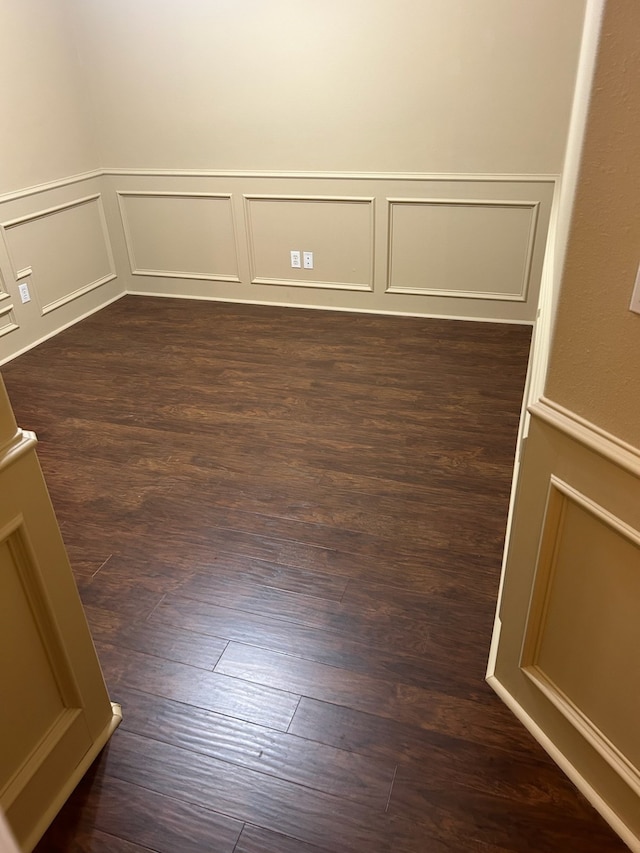 unfurnished room featuring dark wood-type flooring