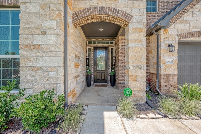 doorway to property with a garage