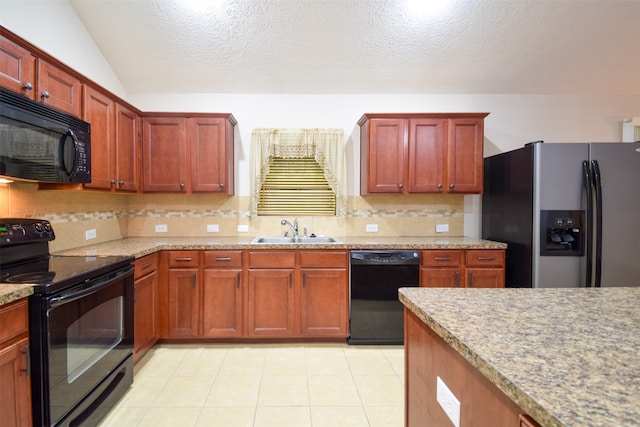 kitchen featuring sink, a textured ceiling, black appliances, vaulted ceiling, and decorative backsplash