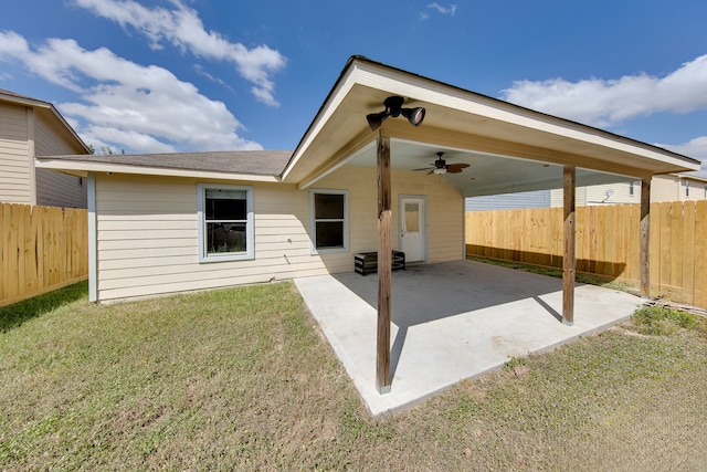 back of property with a lawn, ceiling fan, and a patio area