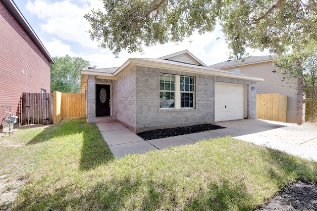 single story home featuring a garage and a front lawn