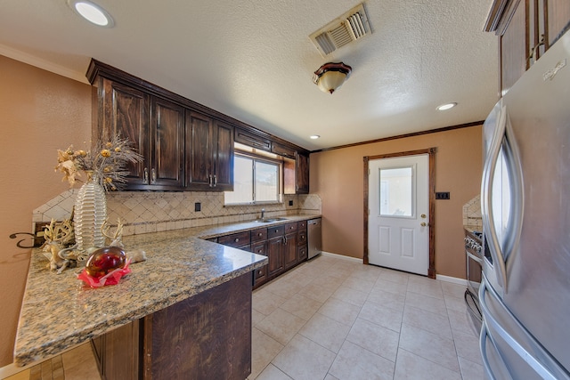 kitchen with backsplash, ornamental molding, stainless steel appliances, and light stone counters