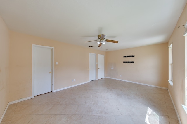 spare room featuring ceiling fan and light tile patterned flooring