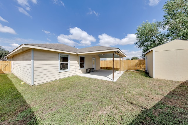 back of property featuring a yard and a patio area