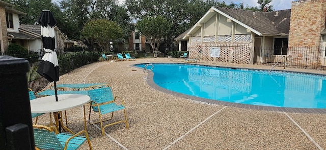 view of swimming pool featuring a patio area