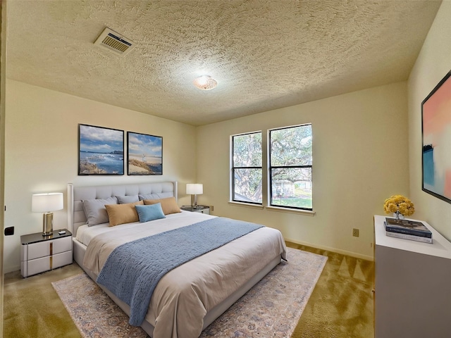 carpeted bedroom featuring a textured ceiling