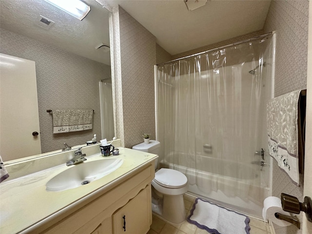 full bathroom with vanity, tile patterned floors, shower / bath combination with curtain, toilet, and a textured ceiling