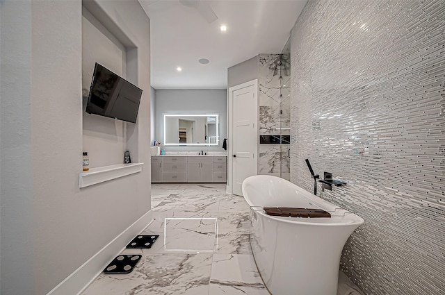 bathroom with vanity and a washtub