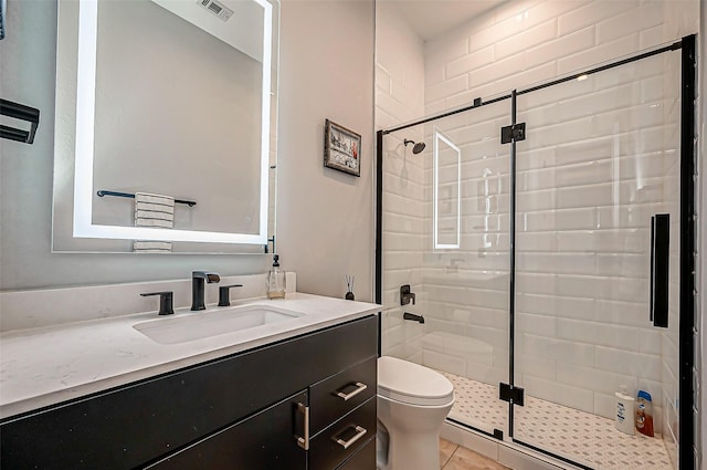 bathroom featuring walk in shower, vanity, and toilet