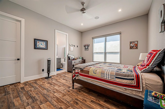 bedroom featuring connected bathroom, hardwood / wood-style floors, and ceiling fan