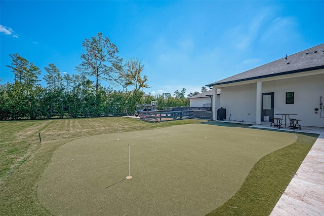 view of community with a patio and a lawn