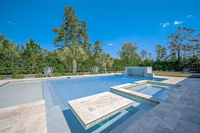 view of swimming pool featuring an in ground hot tub and a patio