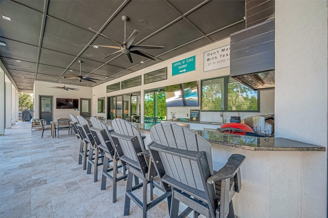 view of patio / terrace with a wet bar and ceiling fan