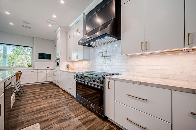 kitchen featuring black range with gas cooktop, white cabinetry, light stone countertops, decorative backsplash, and exhaust hood