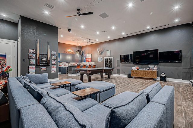 living room featuring billiards, ceiling fan, and light wood-type flooring