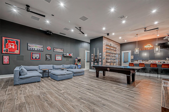 recreation room with hardwood / wood-style flooring, pool table, and bar area