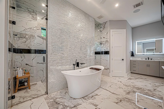 bathroom featuring vanity and shower with separate bathtub