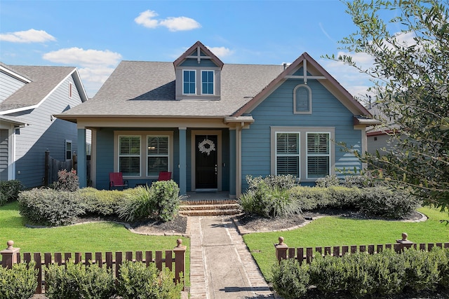 view of front of house featuring covered porch and a front yard