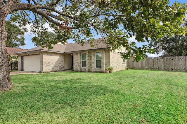 ranch-style home with a front yard and a garage