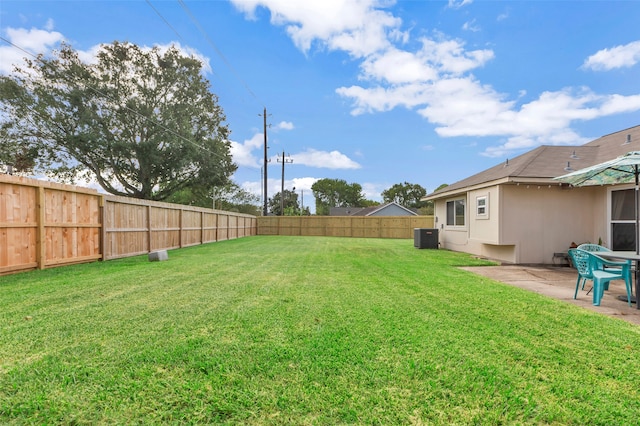 view of yard featuring cooling unit and a patio area