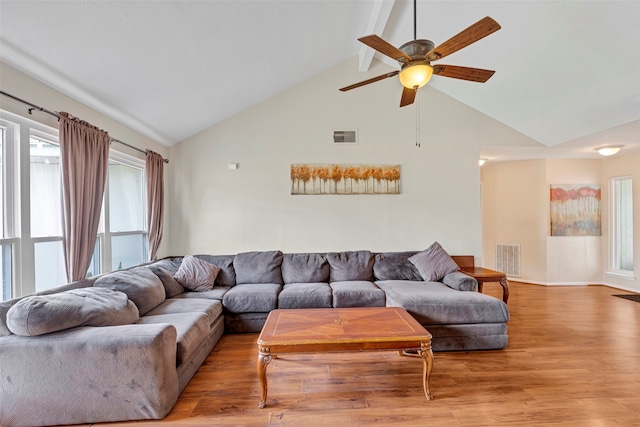 living room featuring ceiling fan, light hardwood / wood-style flooring, plenty of natural light, and high vaulted ceiling